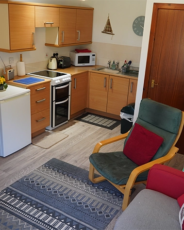A warm, welcoming kitchen and lounge area — perfect for quiet breakfasts or curling up with a book